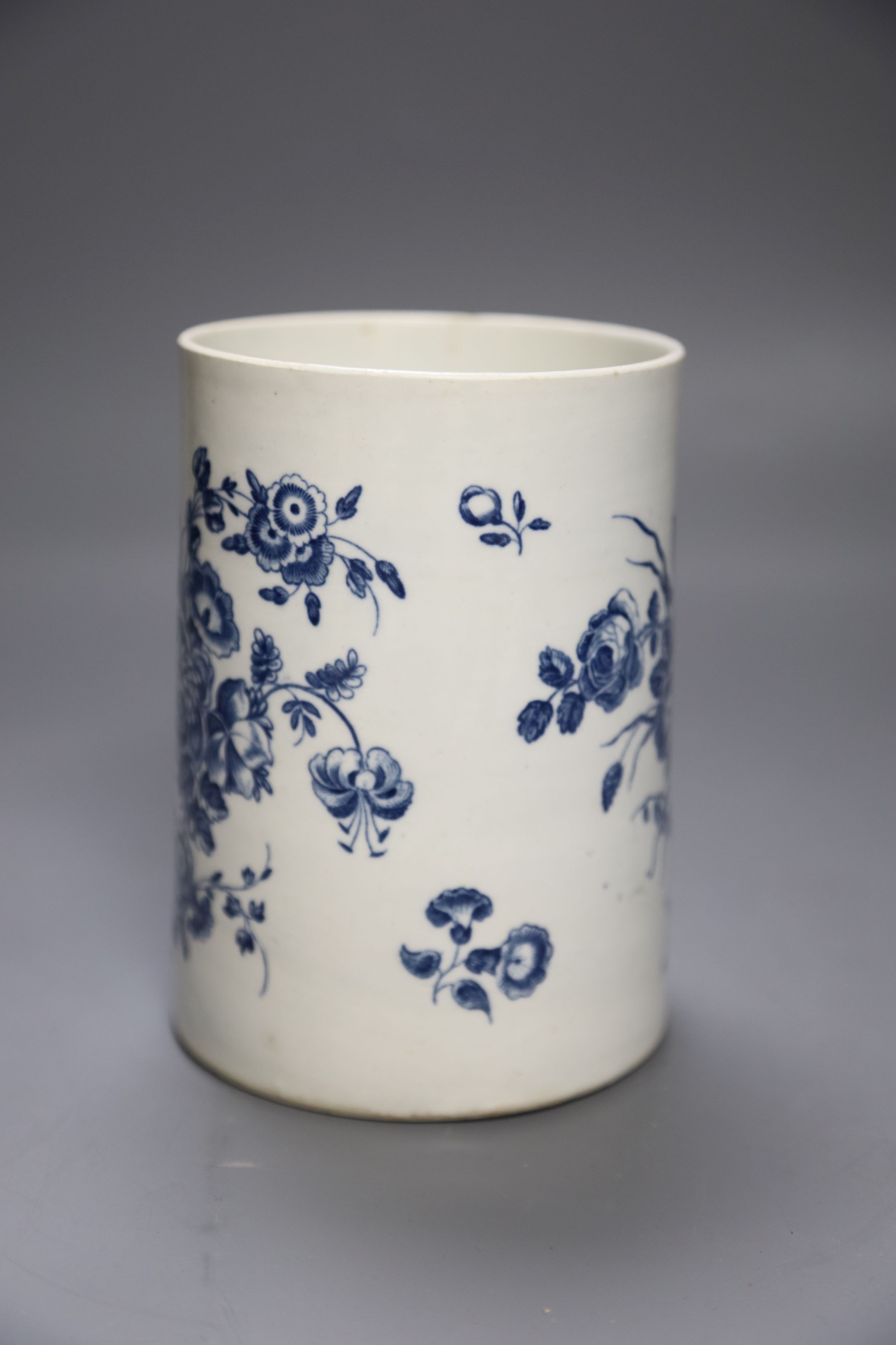 A Worcester cylindrical mug decorated in blue under glaze two large floral sprays, height 14cm